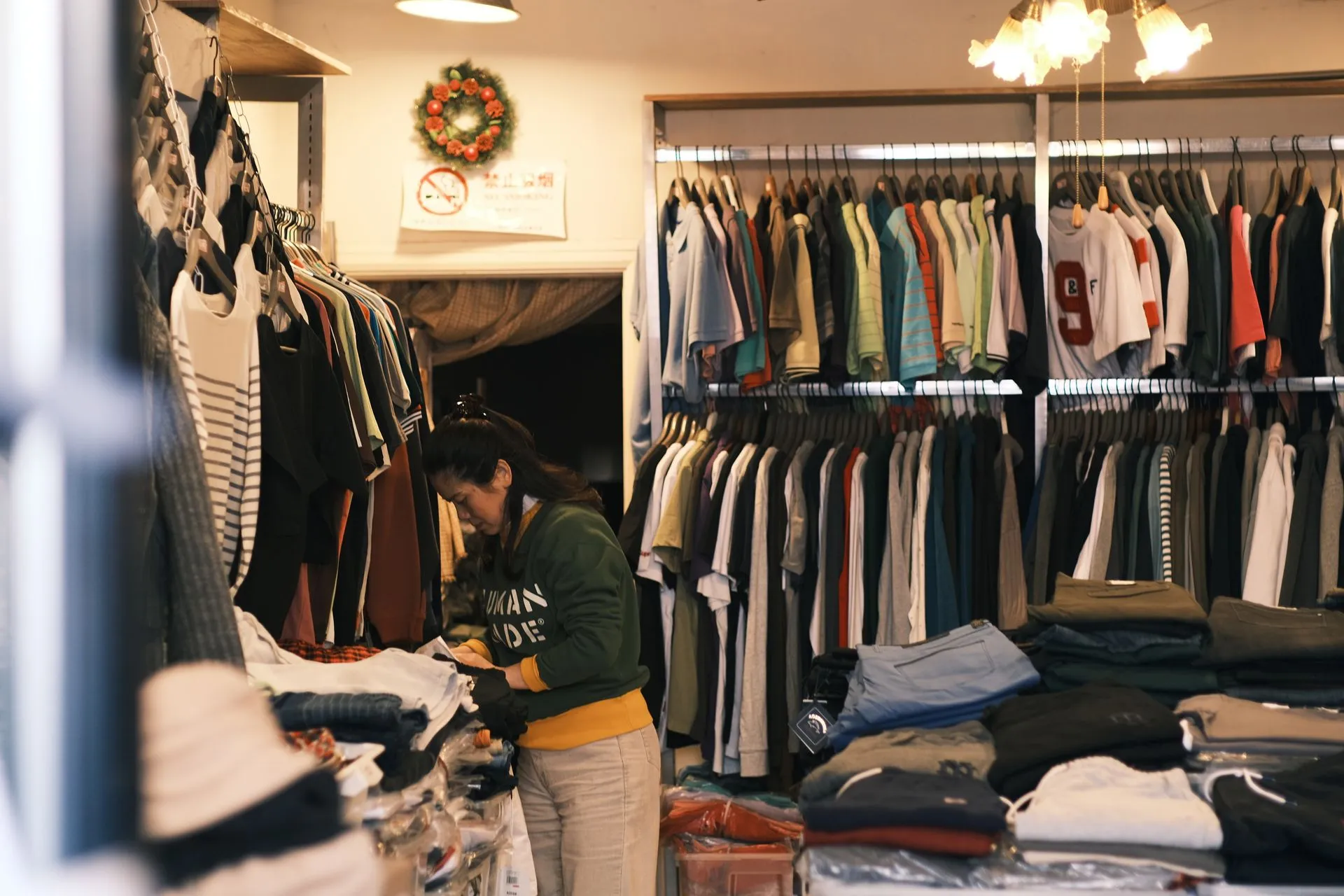 Mujer ordenando prendas en una tienda de ropa
