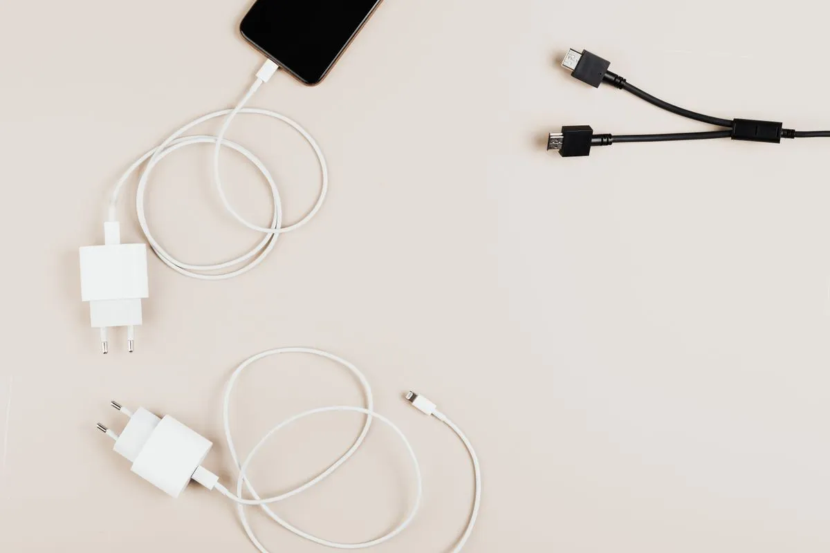 Cargadores y cables junto a un celular