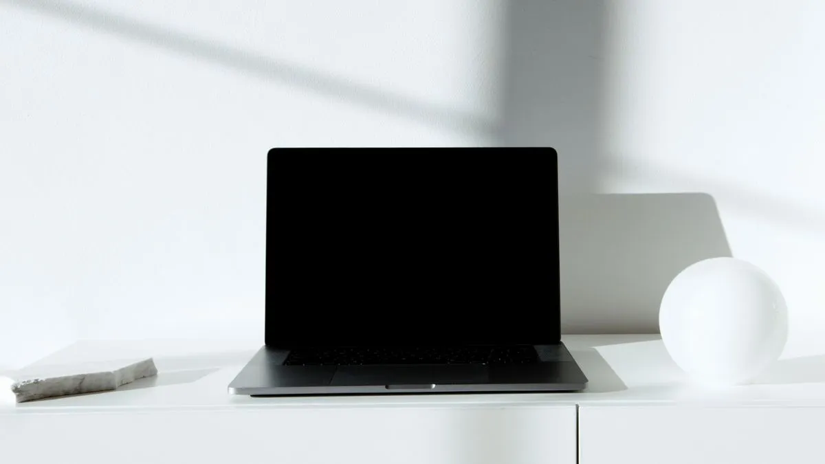 Laptop abierta sobre un mueble blanco